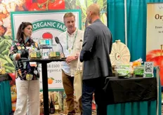 Aimee and Andy Martin from A&A Organic Produce, talking with a visitor.