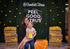 Denise Junqueiro and her daughter Ella on the swing in the Sunkist booth.