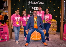 Christian Harris with Sunkist on the swing at the Sunkist booth. Behind him is Sunkist's marketing team.
